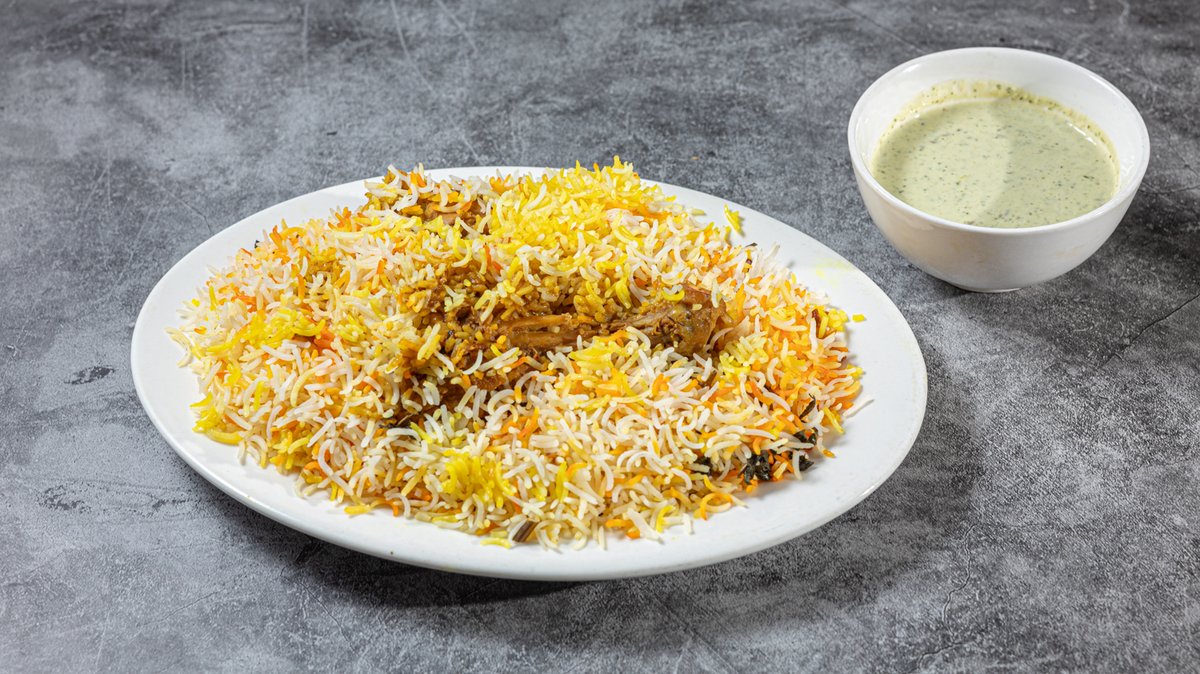 Pakistani chicken biryani served with raita